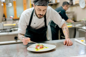 Chef preparing raw meat dish in kitchen Chef preparing raw meat dish in kitchen